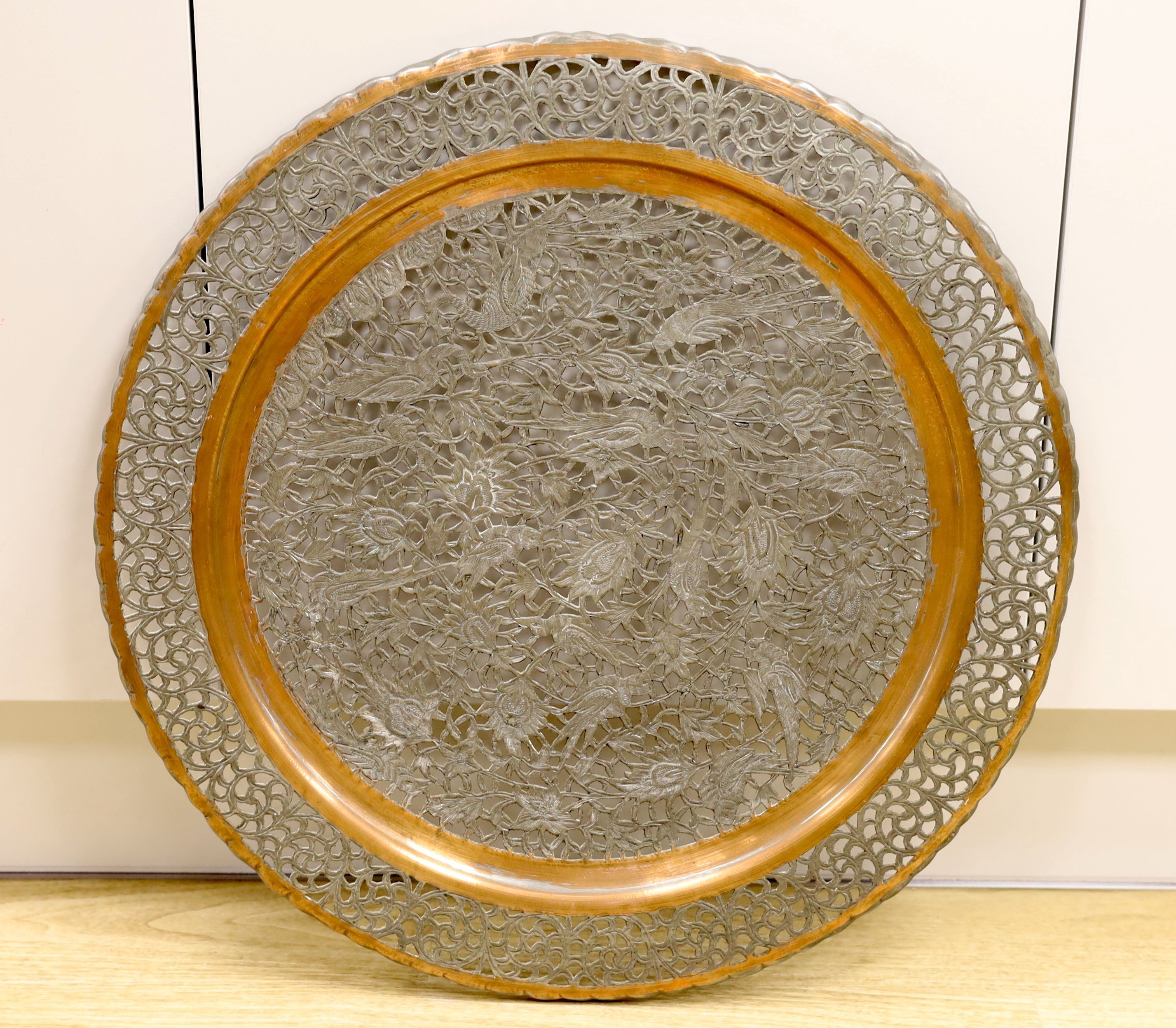 A Persian tinned copper pierced dish top, 54 cms diameter.